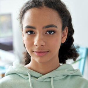Young middle school girl looking at the viewer