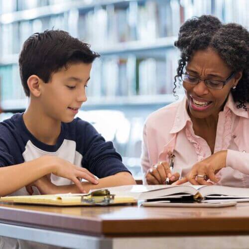 Teacher and student working on reading skills